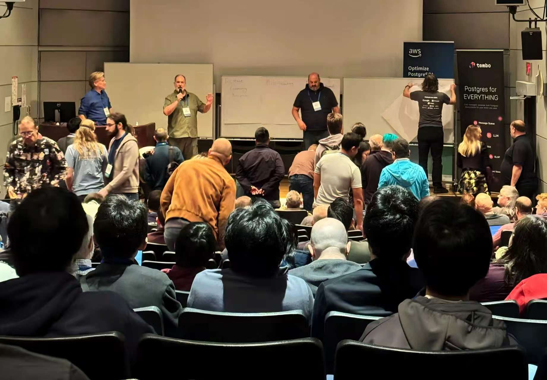 Open-source developers and attendees exchanging ideas after a conference session